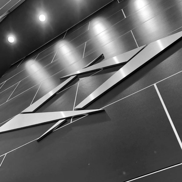 Black and white image of the Diamond logo on a brick wall.