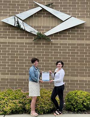 karliegh P receiving her scholarship at the Exeter branch.