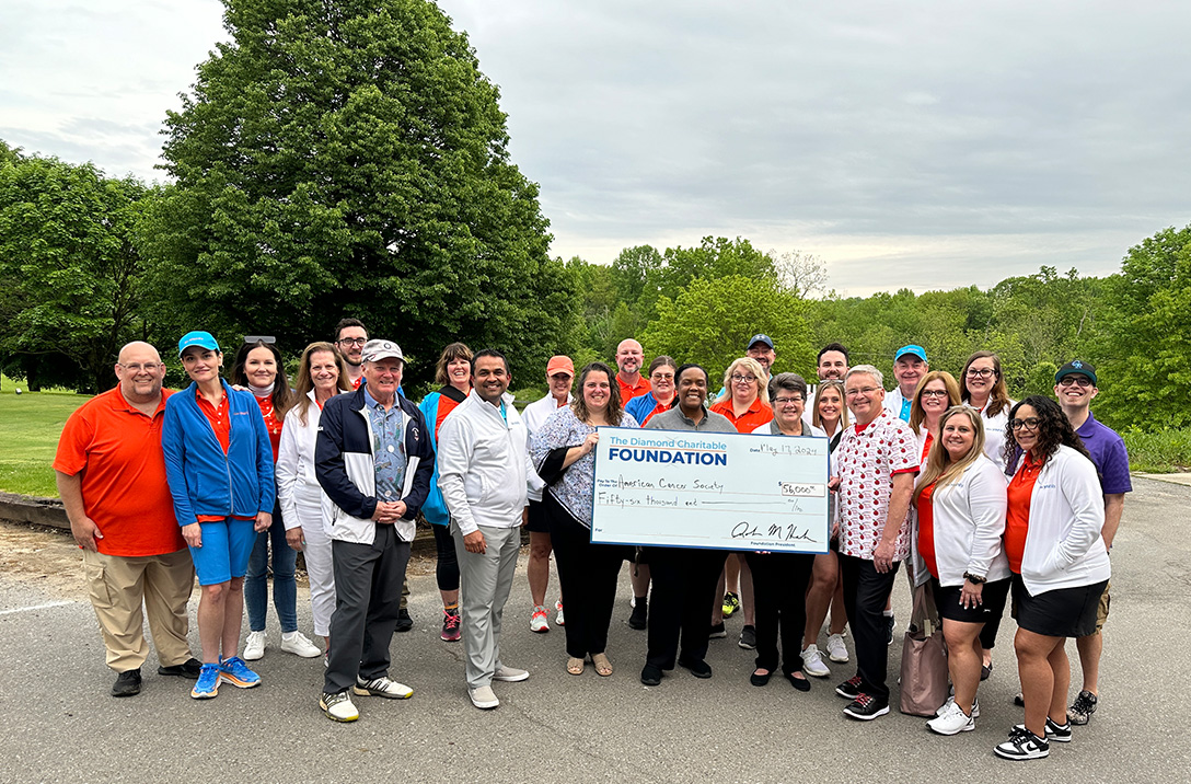 Diamond employees holding The Diamond Charitable Foundation big check for the American Cancer Society