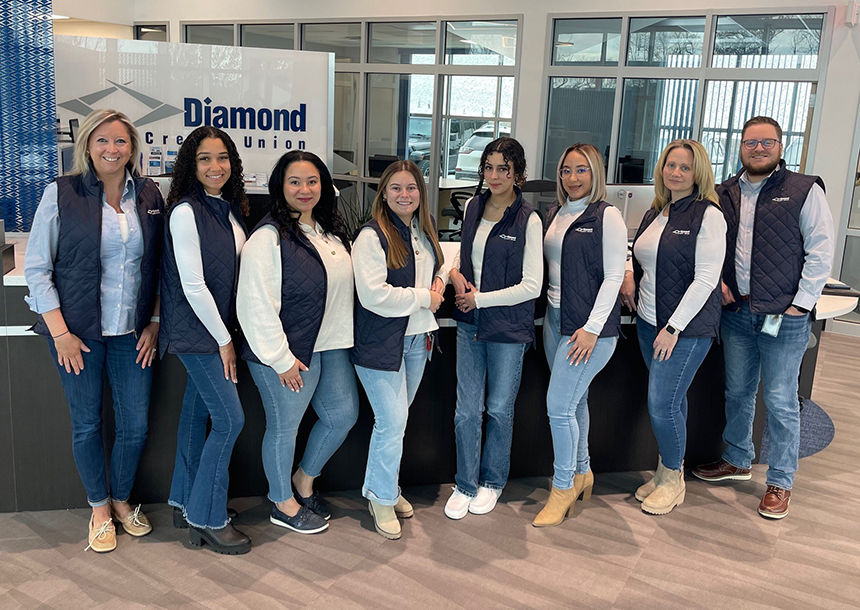 All Diamond branches are well staffed with teams like their Cumru branch, which are pictured here. Eight team members are pictured wearing their navy blue Diamond vests, standing in front of the service-first desk inside the Cumru branch.